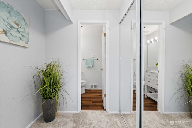 hallway with light colored carpet