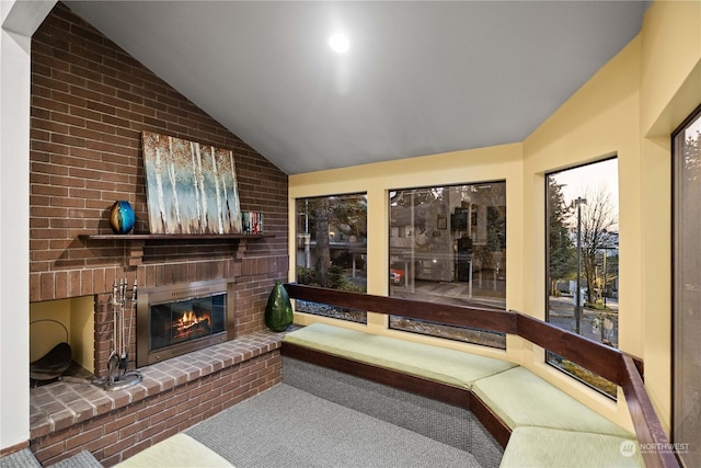 interior space with vaulted ceiling and a fireplace