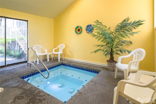 view of swimming pool featuring an indoor hot tub