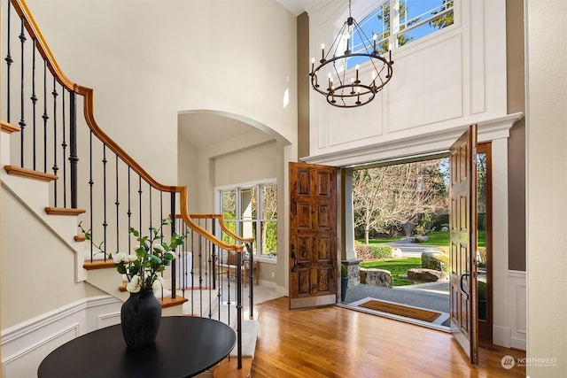 foyer entrance featuring hardwood / wood-style flooring and an inviting chandelier