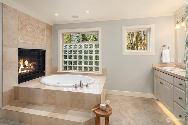 bathroom with tiled tub, vanity, and ornamental molding