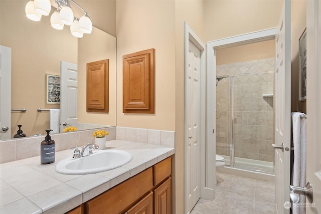 bathroom with toilet, walk in shower, tile patterned floors, and vanity