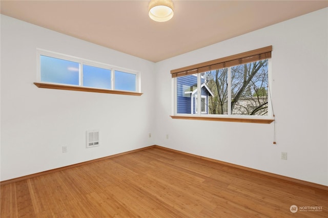 spare room with wood-type flooring