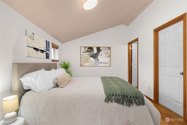 bedroom featuring hardwood / wood-style flooring and lofted ceiling