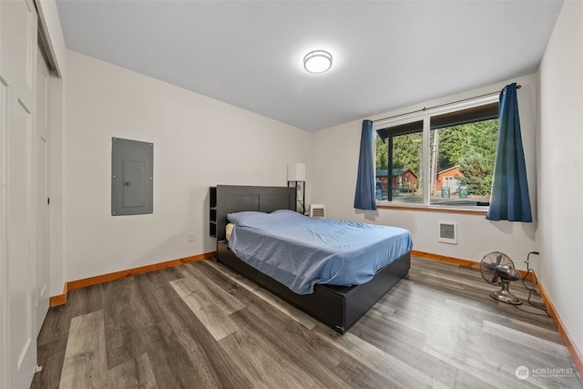 bedroom with hardwood / wood-style flooring and electric panel