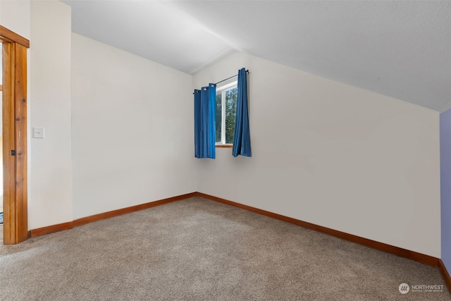 bonus room with lofted ceiling and carpet