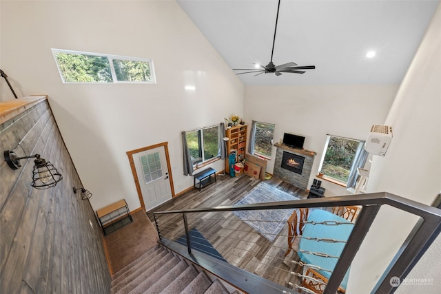 living room featuring ceiling fan, wood-type flooring, and high vaulted ceiling