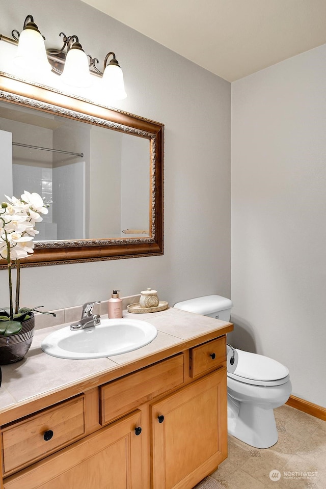 bathroom featuring vanity and toilet