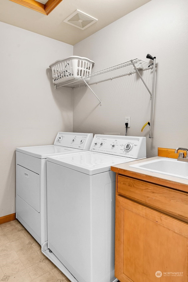 laundry room with cabinets and washing machine and dryer