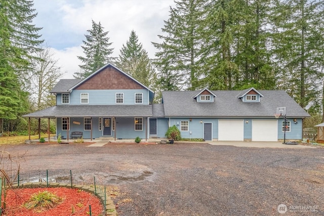 view of front of house with a garage, covered porch, and dirt driveway