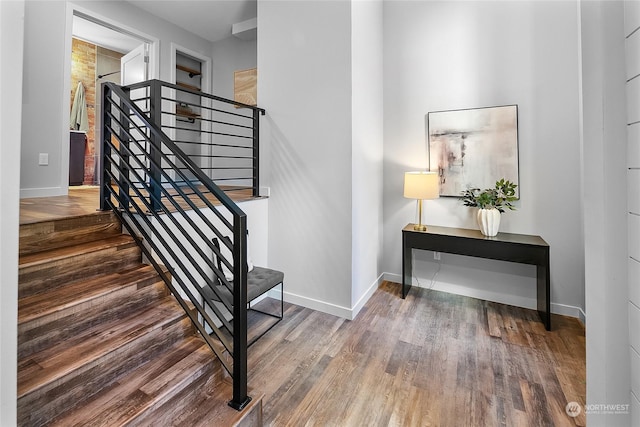 stairs featuring hardwood / wood-style floors