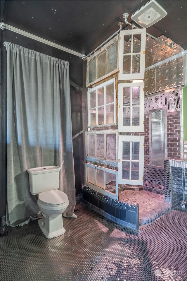 bathroom featuring ornamental molding and toilet