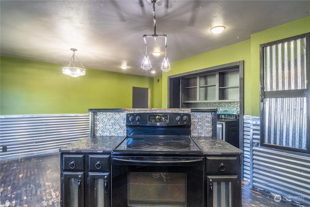 kitchen with tasteful backsplash, a kitchen island, hanging light fixtures, and electric range