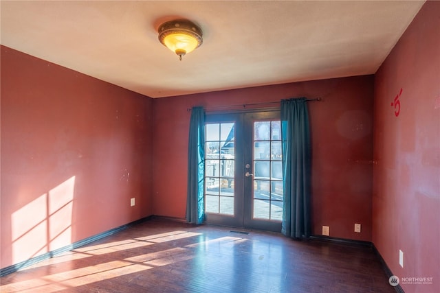 unfurnished room with hardwood / wood-style flooring and french doors