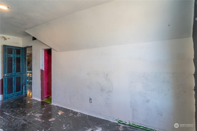 empty room with vaulted ceiling