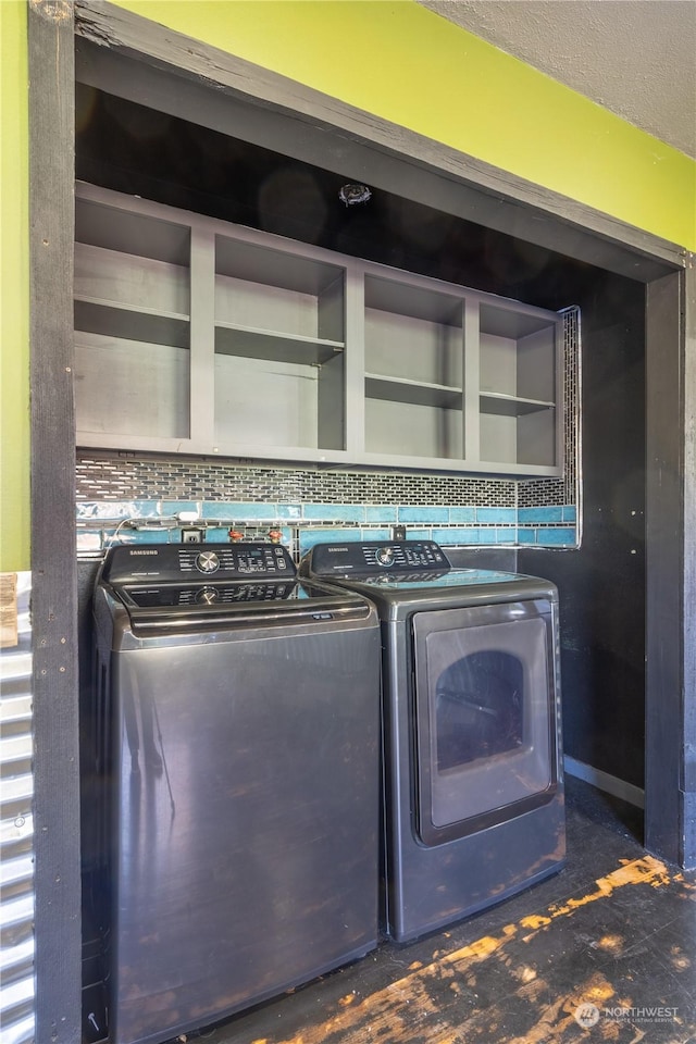 laundry area featuring separate washer and dryer and a textured ceiling