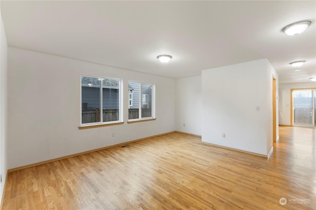 spare room with light hardwood / wood-style floors