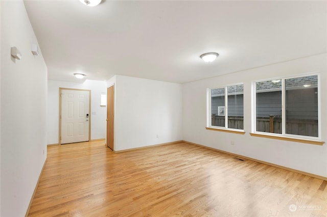 spare room with light hardwood / wood-style floors