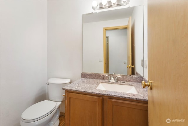 bathroom featuring toilet and vanity