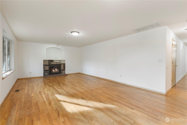 unfurnished living room with light hardwood / wood-style floors and a fireplace