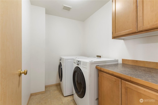 laundry room featuring cabinets and independent washer and dryer