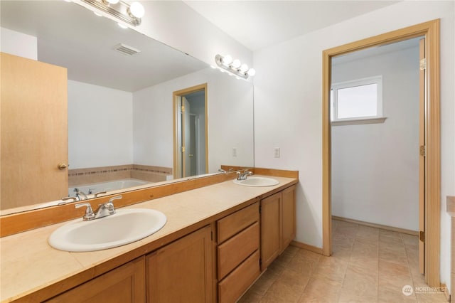 bathroom featuring a bath and vanity