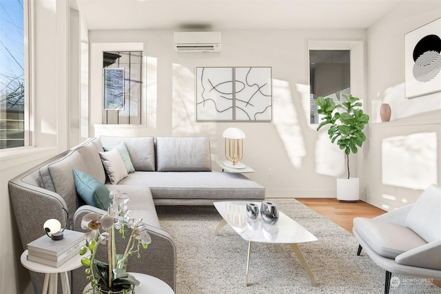 living room with a wall mounted air conditioner and hardwood / wood-style floors