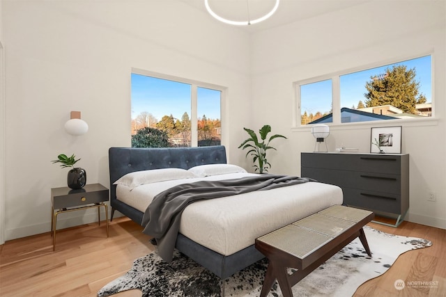 bedroom featuring multiple windows and light wood-type flooring