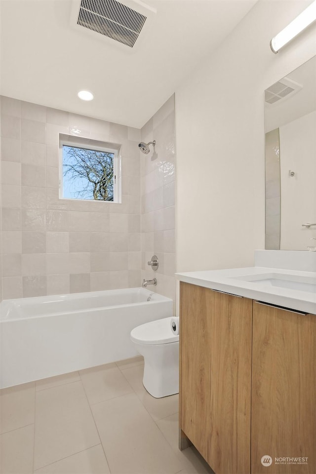 full bathroom featuring tiled shower / bath, vanity, toilet, and tile patterned flooring