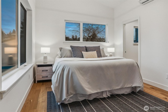 bedroom featuring dark wood finished floors and baseboards