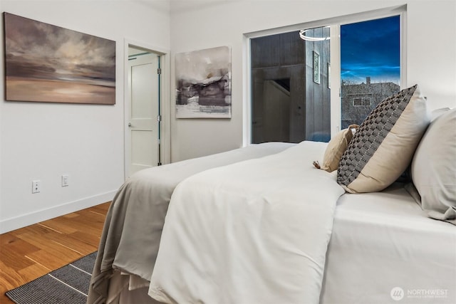 bedroom featuring baseboards and wood finished floors