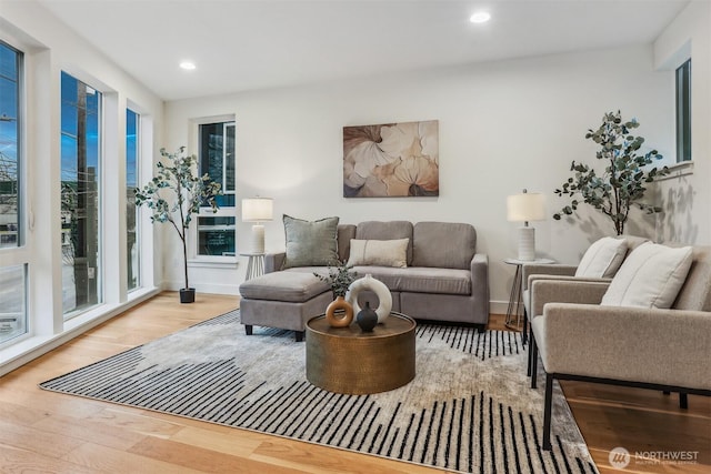 living room featuring recessed lighting, baseboards, and wood finished floors