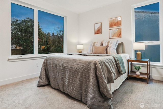 carpeted bedroom featuring baseboards