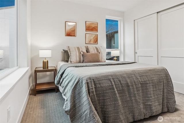 bedroom with carpet and baseboards