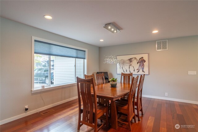 dining area featuring dark wood-type flooring