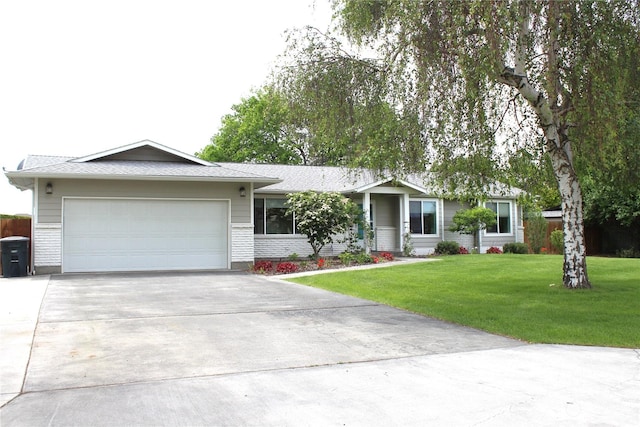 ranch-style house with a garage and a front lawn