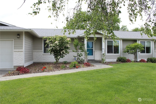 single story home featuring a garage and a front lawn