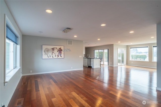 interior space with sink and hardwood / wood-style flooring