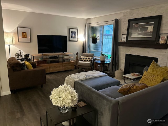 living room featuring dark wood-type flooring and a fireplace