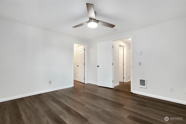 unfurnished bedroom with dark wood-type flooring, heating unit, and ceiling fan