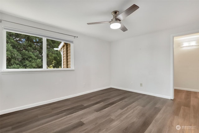 spare room with ceiling fan and dark hardwood / wood-style floors