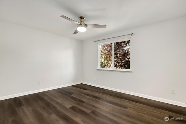 spare room with ceiling fan and dark hardwood / wood-style flooring