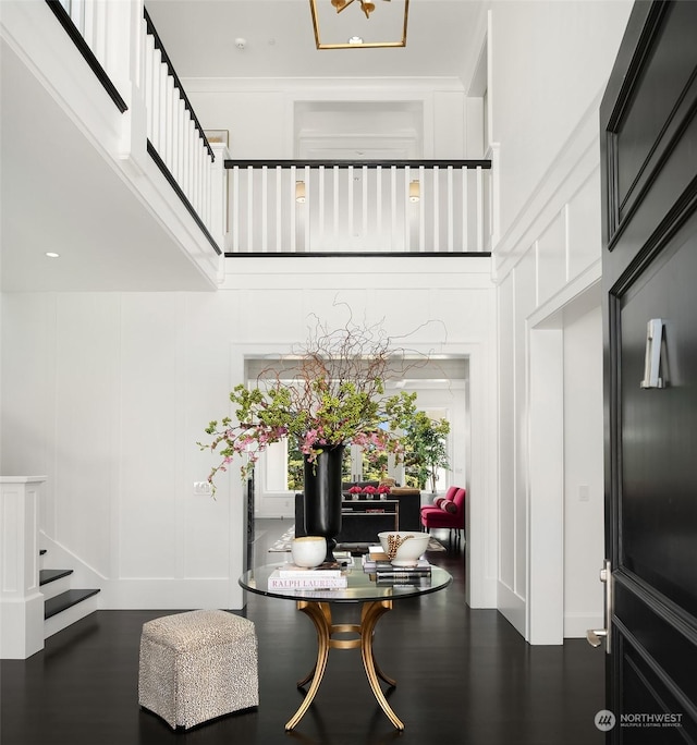 dining room with dark wood-type flooring and a high ceiling