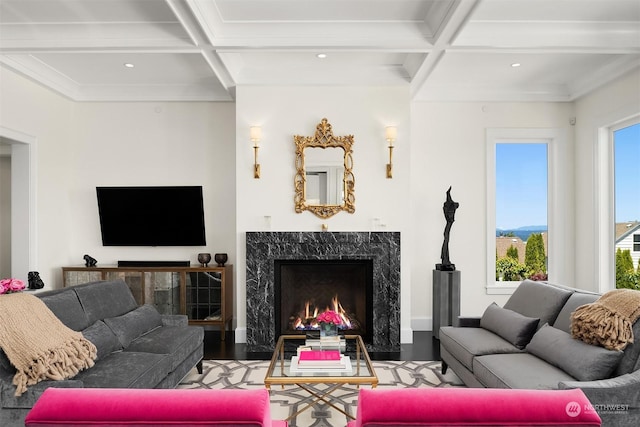 living room with coffered ceiling, beamed ceiling, a high end fireplace, and ornamental molding