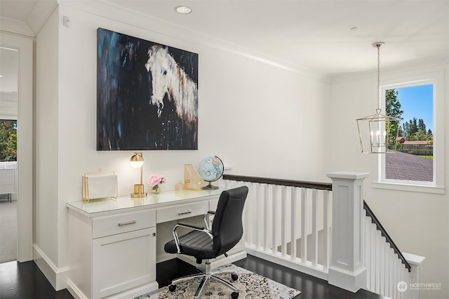 office area featuring plenty of natural light, crown molding, and built in desk