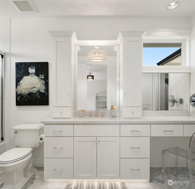 bathroom featuring toilet and vanity