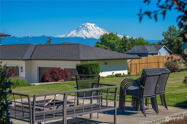 view of property's community with a mountain view and a yard