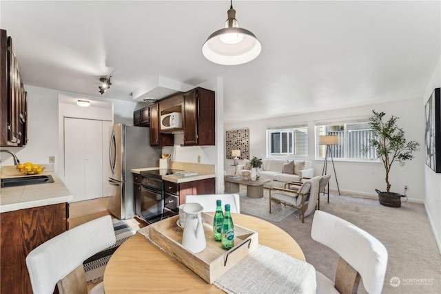 carpeted dining room featuring sink