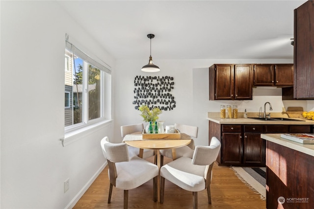 dining room featuring sink and light wood-type flooring