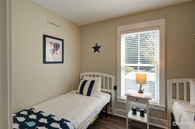 bedroom featuring dark wood-type flooring and baseboards